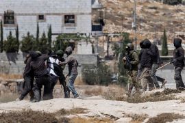Israeli settlers, some holding sticks, scuffle with left-wing activists as Israeli soldiers intervene at an Israeli outpost in the Israeli-occupied Palestinian village of Jannatah, just south of the city of Bethlehem on August 25, 2026. Violence in the Palestinian West Bank, which Israel has occupied since 1967, has soared since the Hamas attack on Israel triggered the Gaza war in October 2023. All Israeli settlements in the West Bank, which has been occupied since 1967, are illegal under international law. (Photo by ilia YEFIMOVICH / AFP via Getty Images)
