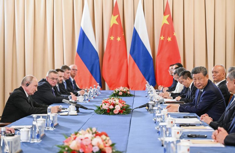 In this pool photograph distributed by the Russian state agency Sputnik, Russia's President Vladimir Putin and China's President Xi Jinping hold a meeting on the sidelines of the Shanghai Cooperation Organisation (SCO) summit in Bishkek on August 31, 2026. (Photo by Kristina Solovyova / POOL / AFP)